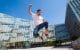 Male uni student leaping in triumph