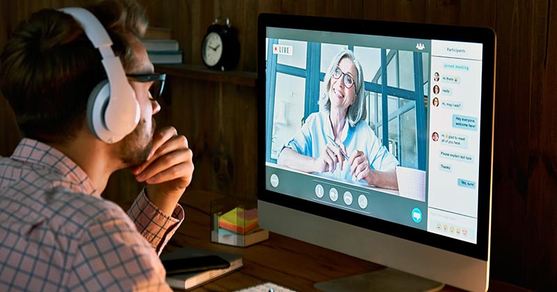 Man wearing headphones watching an on-screen presentation