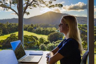 University student with bush views from home office