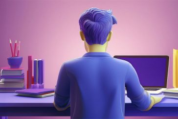 Young man using laptop on desk with books