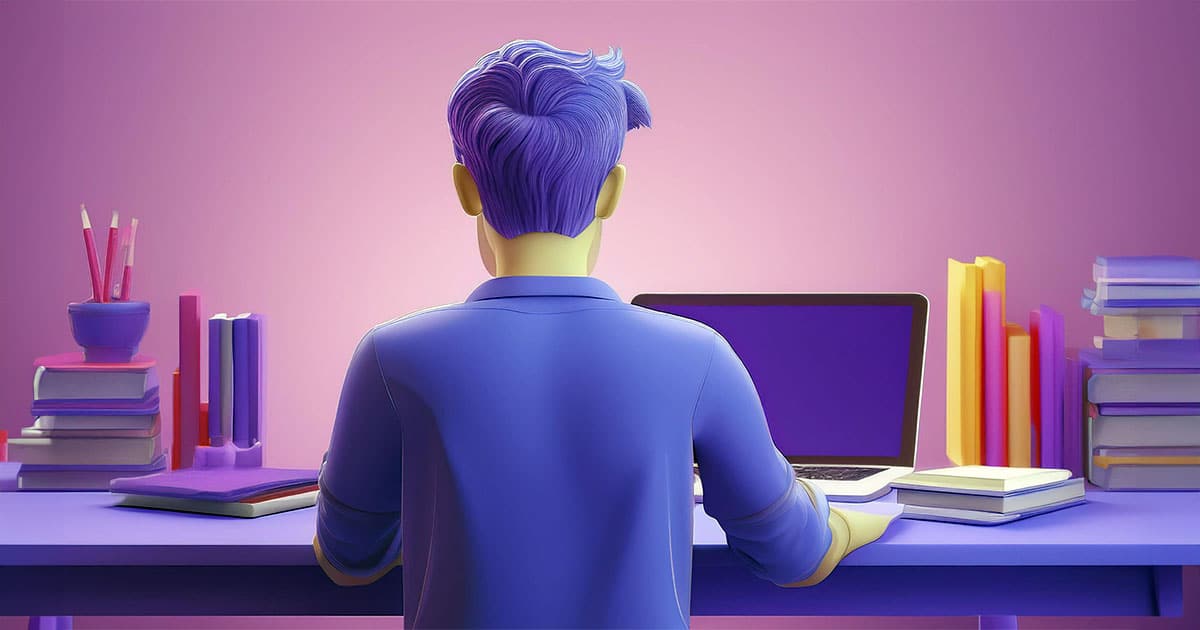 Young man using laptop on desk with books