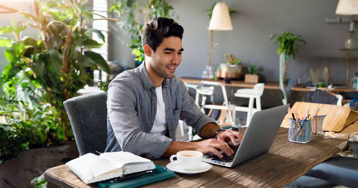 Young man working at laptop on desk