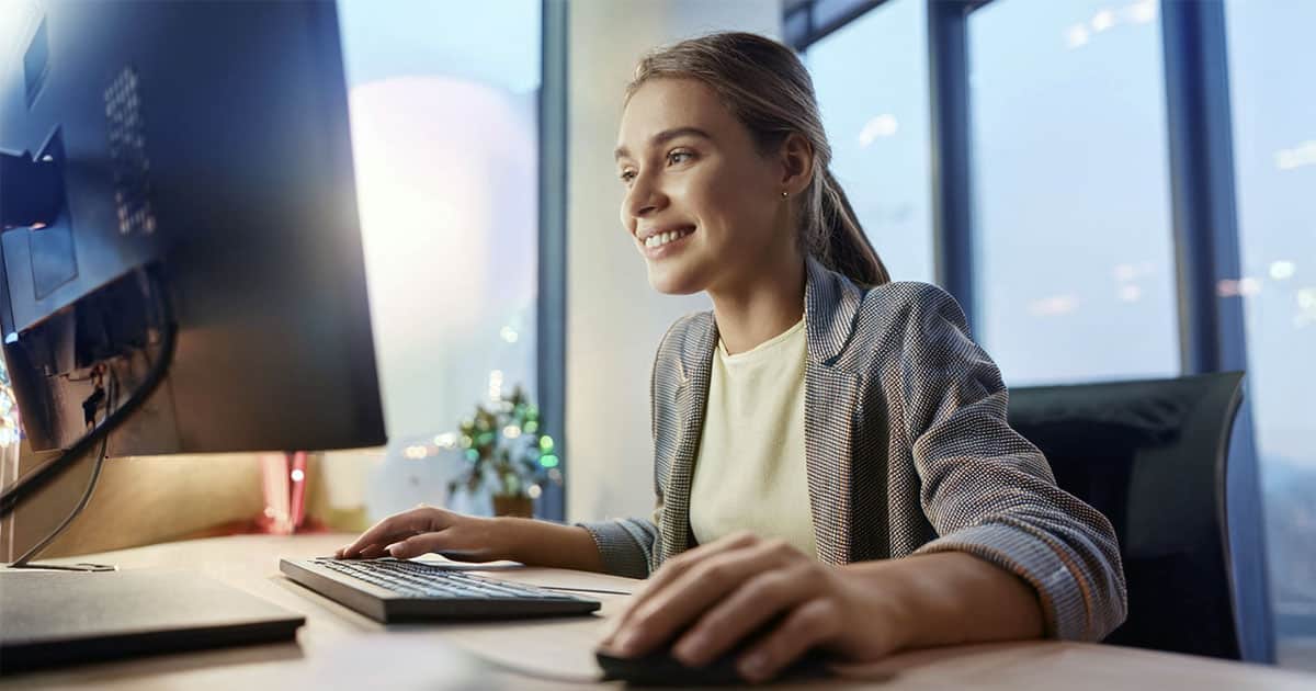 Young smiling woman using computer